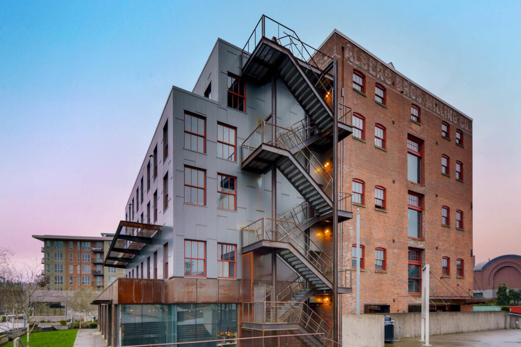 Building exterior with balconies and fire escape stairs