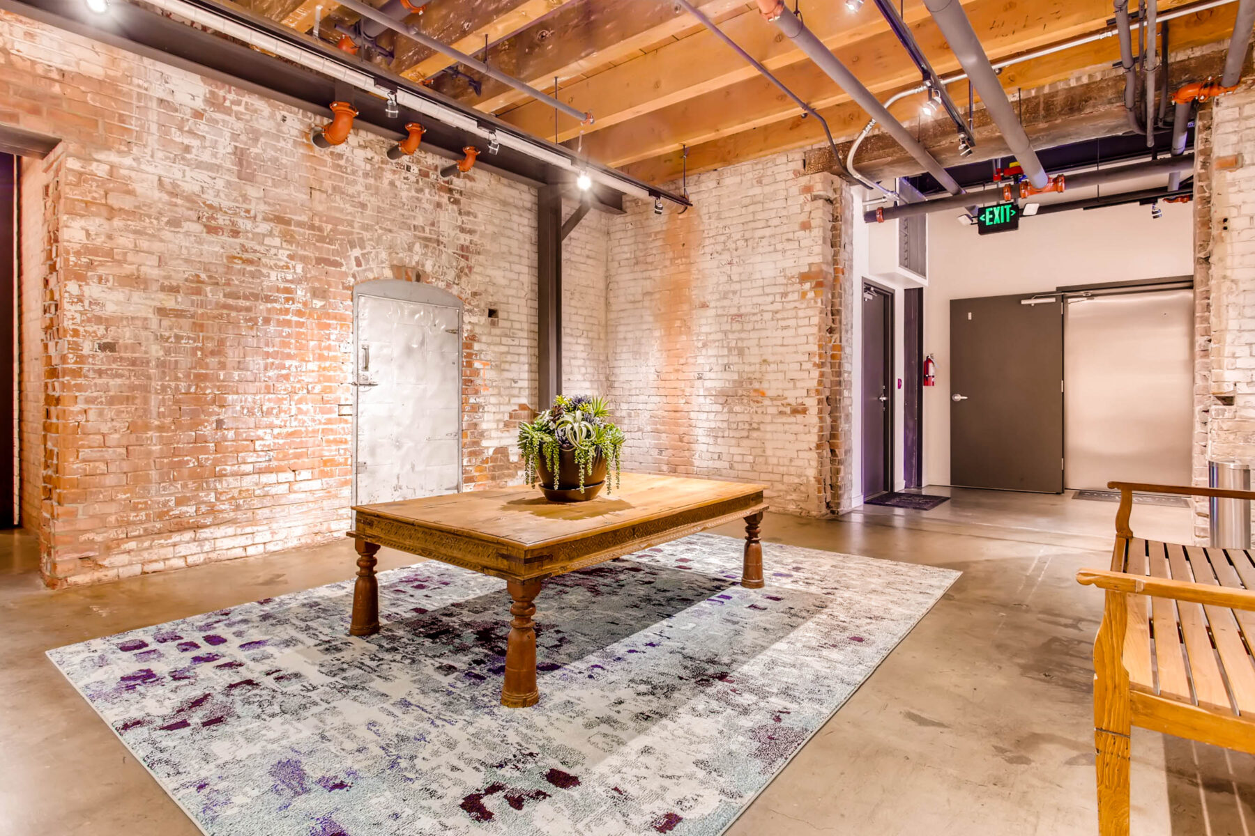 Lobby with bare brick walls and exposed fixtures