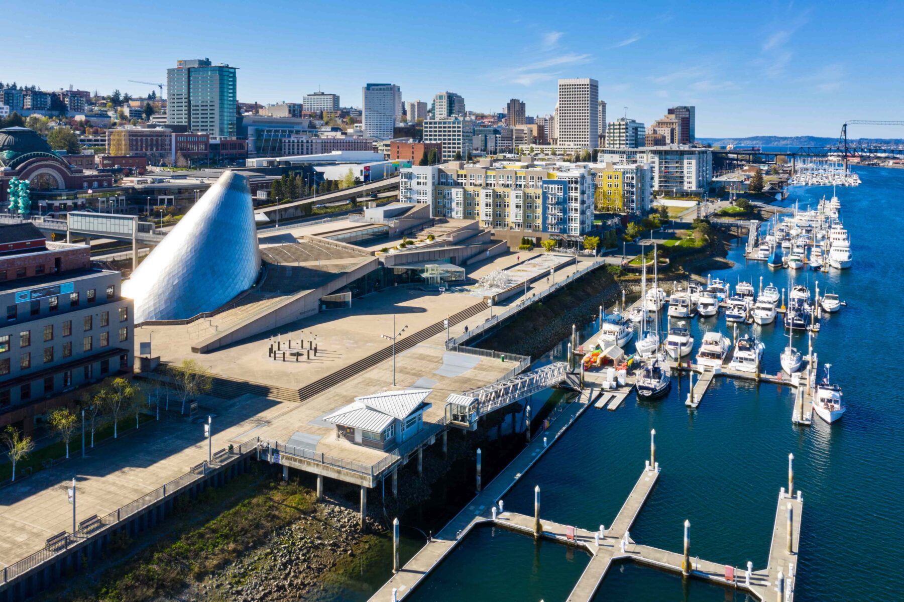 Aerial view of Tacoma Washington with a marina in the foreground and city skyline in the background