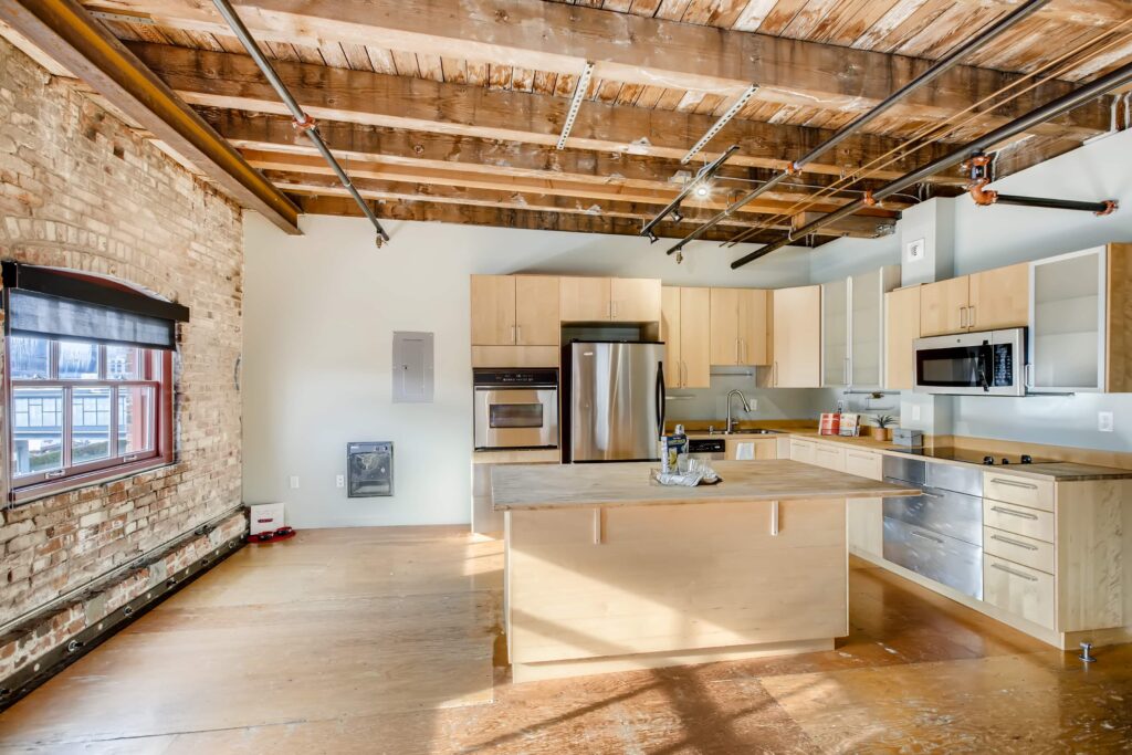 Open kitchen with wooden and glass cabinets, stainless steel appliances and kitchen Island