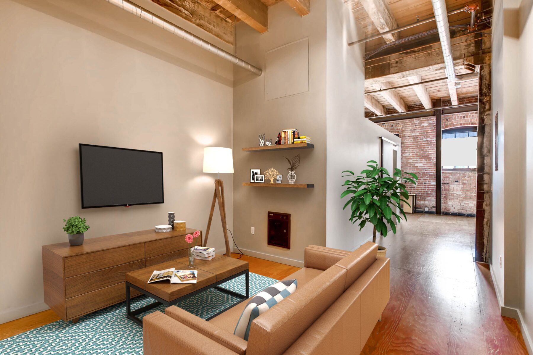 Living room with a couch, coffee table and a wall mounted TV