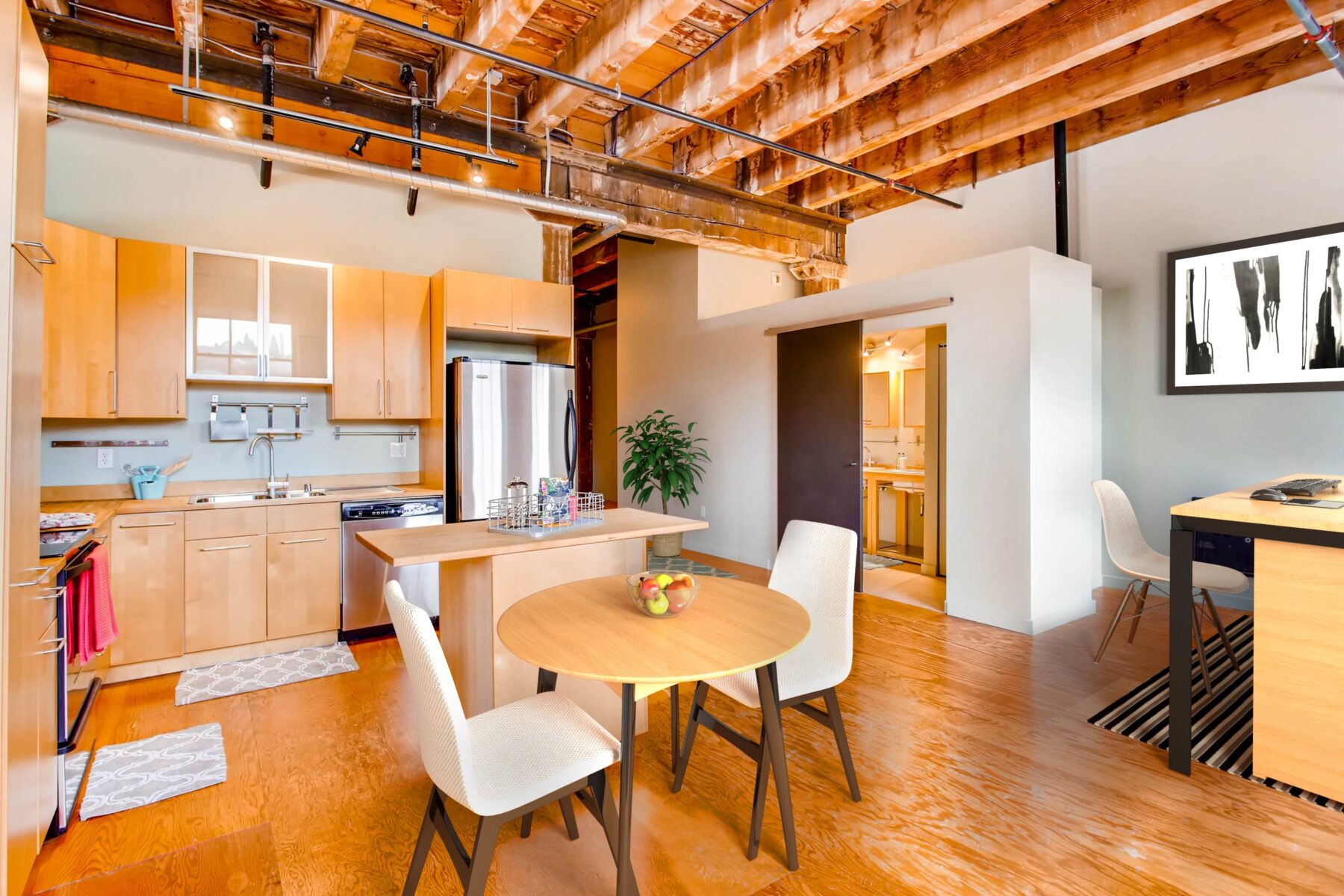 Open kitchen with wooden and glass cabinets, stainless steel appliances